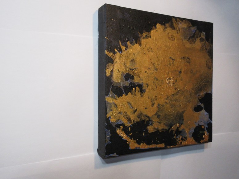 A shapeless Gold acrylic and gold leaf over top a black negative space