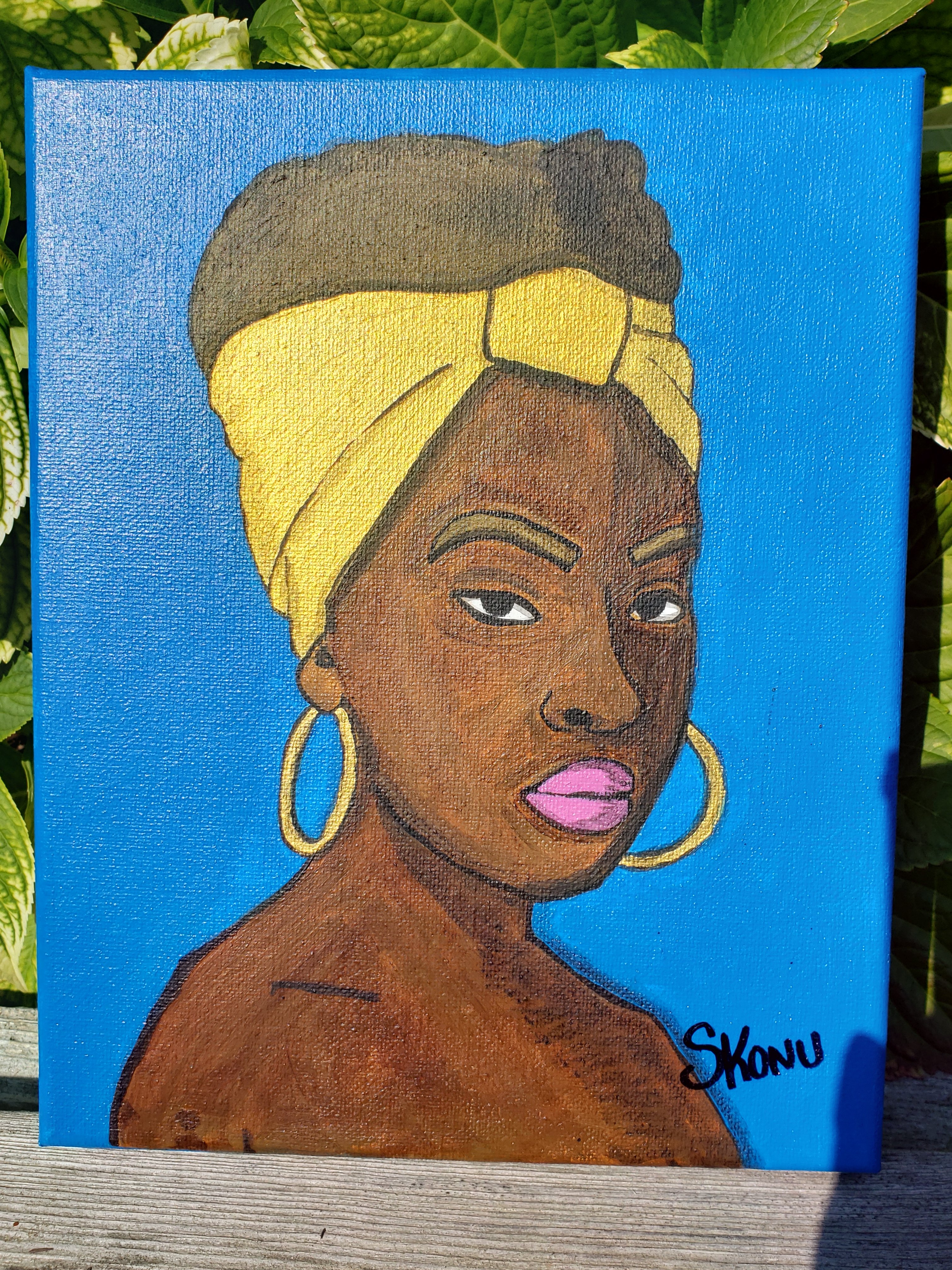 African woman with gold accent and blue background  acrylic on canvas by Stephanie Konu 